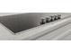 Modern cooktop with sleek black surface, stainless steel trim and chrome control knobs at 5648 Cedar Chase Dr, St Cloud, FL 34771