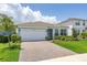 Beautiful home featuring a brick driveway, lush lawn, and manicured landscaping at 5648 Cedar Chase Dr, St Cloud, FL 34771
