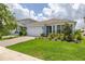 Beautiful home featuring a brick driveway, lush lawn, and manicured landscaping at 5648 Cedar Chase Dr, St Cloud, FL 34771