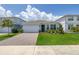 Charming single-Gathering home with a well-manicured lawn, brick driveway, and beautiful landscaping at 5648 Cedar Chase Dr, St Cloud, FL 34771