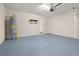Bright and spacious garage with epoxy flooring and a hot water heater at 5648 Cedar Chase Dr, St Cloud, FL 34771