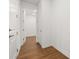 Hallway with white trim and wood flooring leads to other rooms in the house at 5648 Cedar Chase Dr, St Cloud, FL 34771