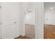 Hallway leads to a carpeted room with a ceiling fan, adjacent to a room with wood flooring at 5648 Cedar Chase Dr, St Cloud, FL 34771