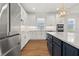 Bright kitchen with white cabinets, stainless steel appliances, and a blue island at 5648 Cedar Chase Dr, St Cloud, FL 34771
