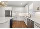 Bright kitchen with white cabinets, stainless appliances, white countertops and wood floor at 5648 Cedar Chase Dr, St Cloud, FL 34771