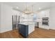 Modern kitchen with white cabinets, stainless steel appliances, and a stylish center island at 5648 Cedar Chase Dr, St Cloud, FL 34771
