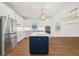Kitchen island with white countertops, navy cabinets, pendant lights and stainless appliances at 5648 Cedar Chase Dr, St Cloud, FL 34771