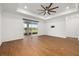 Open living room features tile floors, a ceiling fan, and sliding glass doors leading to the outdoor space at 5648 Cedar Chase Dr, St Cloud, FL 34771