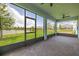 Screened porch with brick pavers, outdoor views, and a screened-in door at 5648 Cedar Chase Dr, St Cloud, FL 34771