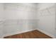 Walk-in closet with wood-look tile flooring and wire shelving at 5648 Cedar Chase Dr, St Cloud, FL 34771