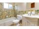 Bathroom featuring decorative tile, tub, and white vanity with sink at 612 Lakeshore Blvd, Kissimmee, FL 34744