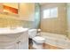 Bathroom offers decorative tile, tub/shower, white vanity with sink, and light at 612 Lakeshore Blvd, Kissimmee, FL 34744