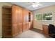 Charming bedroom with tile floors, ceiling fan, and ample built-in storage at 612 Lakeshore Blvd, Kissimmee, FL 34744