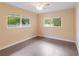 Neutral bedroom features tile floors, two windows, and neutral paint at 612 Lakeshore Blvd, Kissimmee, FL 34744