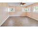 This bedroom offers tile floors, two windows with shutters, and a ceiling fan at 612 Lakeshore Blvd, Kissimmee, FL 34744
