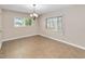 Bright dining room featuring tile flooring, a chandelier, and natural light from two windows at 612 Lakeshore Blvd, Kissimmee, FL 34744