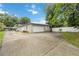 View of the home's garages, driveway, and well-maintained landscaping at 612 Lakeshore Blvd, Kissimmee, FL 34744
