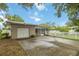 An exterior view of the home, showcasing the screened in porch, picket fence, and landscaping at 612 Lakeshore Blvd, Kissimmee, FL 34744