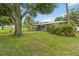 Lovely single-story home with lush landscaping, mature trees, and a brick-paved walkway at 612 Lakeshore Blvd, Kissimmee, FL 34744