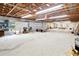 The home has an unfinished garage featuring high ceilings, concrete floors, and exposed rafters at 612 Lakeshore Blvd, Kissimmee, FL 34744