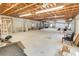This is a photo of the home's unfinished garage with concrete floors and exposed rafters at 612 Lakeshore Blvd, Kissimmee, FL 34744