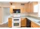 Kitchen featuring wood cabinetry, tile flooring, and modern appliances at 612 Lakeshore Blvd, Kissimmee, FL 34744