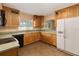 Updated kitchen featuring wood cabinetry, tile flooring, and modern appliances at 612 Lakeshore Blvd, Kissimmee, FL 34744