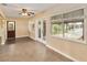 Open-concept living room featuring tile flooring, ceiling fan, and natural light at 612 Lakeshore Blvd, Kissimmee, FL 34744