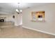 Open-concept living room featuring tile flooring, fireplace and open view to kitchen with breakfast bar at 612 Lakeshore Blvd, Kissimmee, FL 34744