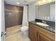Well-lit bathroom with a modern shower, vanity, and tiled floors at 626 Orange Dr # 243, Altamonte Springs, FL 32701