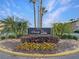Welcome to Sandy Cove Condominiums sign with manicured landscaping, creating a welcoming entrance at 626 Orange Dr # 243, Altamonte Springs, FL 32701