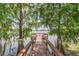 Wooden dock on the lake surrounded by trees, offering a serene spot for relaxation and enjoying the water at 626 Orange Dr # 243, Altamonte Springs, FL 32701