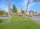 Well-maintained building exterior with lush green lawn, manicured trees, and ample parking spaces at 626 Orange Dr # 243, Altamonte Springs, FL 32701