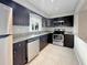 Modern kitchen with stainless steel appliances, dark cabinets, and granite countertops at 626 Orange Dr # 243, Altamonte Springs, FL 32701