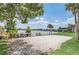 Sandy volleyball court with kayaks, set by a lake and lush greenery at 626 Orange Dr # 243, Altamonte Springs, FL 32701