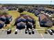 Aerial view of community featuring well-manicured lawns, a pond, and ample parking at 658 Caribbean Dr, Davenport, FL 33897