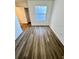 Bright bedroom with neutral walls and laminate wood-look flooring at 658 Caribbean Dr, Davenport, FL 33897