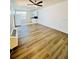 Open-concept living room featuring vinyl floors, white walls, and a ceiling fan at 658 Caribbean Dr, Davenport, FL 33897