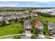 Beautiful aerial view showcasing a well-maintained lawn, mature landscaping, and a community pool at 7541 Marker Ave, Kissimmee, FL 34747