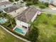 Aerial shot of a home's backyard with a private pool, spa, and well-manicured lawn at 7541 Marker Ave, Kissimmee, FL 34747