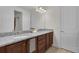 Bathroom featuring double sink vanity with granite countertop and ample storage space at 7541 Marker Ave, Kissimmee, FL 34747
