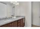 Bathroom featuring double sink vanity with granite countertop and ample storage space at 7541 Marker Ave, Kissimmee, FL 34747