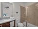 This bathroom has a walk-in shower, a granite countertop, and soft lighting at 7541 Marker Ave, Kissimmee, FL 34747