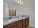 Bathroom featuring double sink with granite countertops and a large mirror at 7541 Marker Ave, Kissimmee, FL 34747