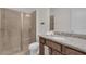 Bathroom featuring granite countertops and glass enclosed tiled shower at 7541 Marker Ave, Kissimmee, FL 34747