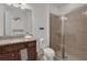 Bathroom showcasing granite countertops, wooden cabinets and glass shower at 7541 Marker Ave, Kissimmee, FL 34747