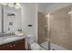 This bathroom has a walk-in shower, a granite countertop, and soft lighting at 7541 Marker Ave, Kissimmee, FL 34747