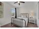 This bedroom features soft light, and a minimalistic design with a modern metal frame bed at 7541 Marker Ave, Kissimmee, FL 34747