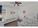 Bright bedroom features two twin beds, ceiling fan, and TV for added comfort and entertainment at 7541 Marker Ave, Kissimmee, FL 34747