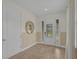 Inviting foyer with neutral tones, tile flooring, and a decorative mirror, creating a bright entrance at 7541 Marker Ave, Kissimmee, FL 34747